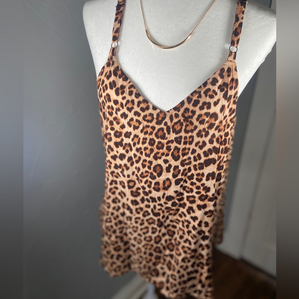 Torrid animal print tank with cross in the back